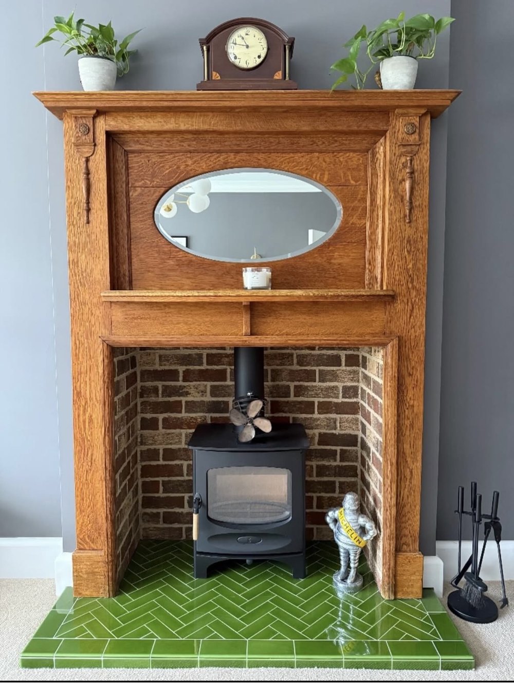 Olive green glazed herringbone tiled hearth manufactured in house by Victorian Fires, under an oak mantel